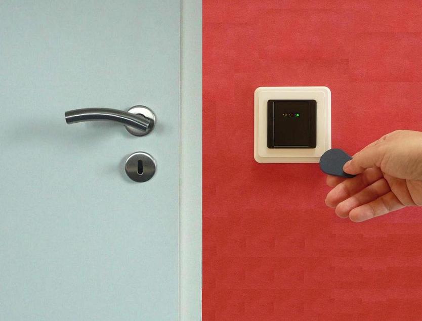 RFID keyfob held against a door access control reader